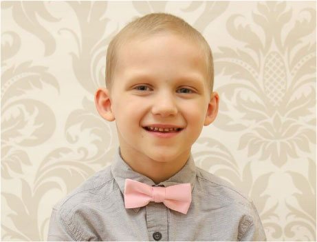 Image of Smiling Boy Wearing a Pink Bowtie